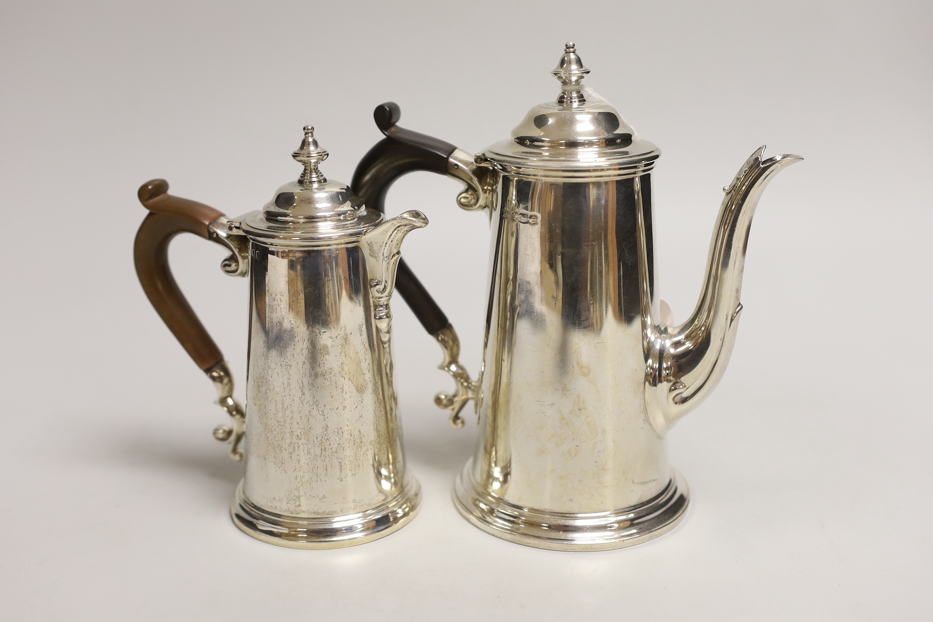 Two George V silver cafe au lait pots, the smaller by Chares & Richard Comyns, London, 1926, gross weight, 18.2oz.